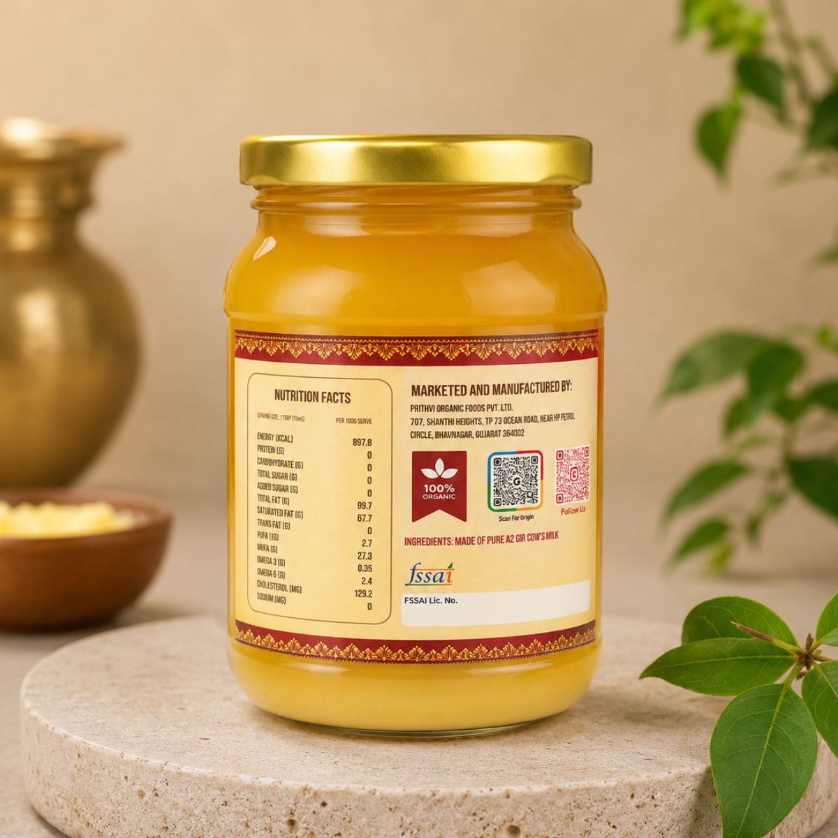 A glass jar of A2 Gir Cow ghee with a gold lid and a cream-colored label